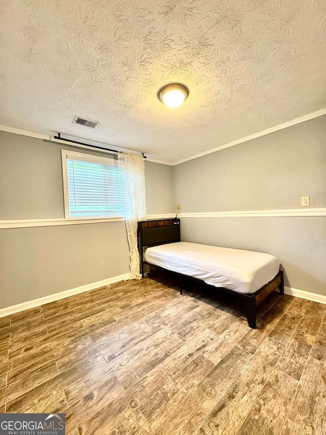 3544 Citrus Dr, Duluth, GA 30096 - bedroom with wood finished floors, a textured ceiling, and ornamental molding
