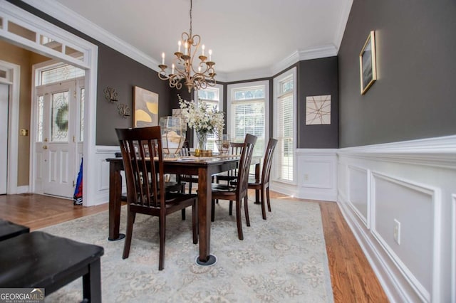 204 Pinehurst Way, Carrollton, GA 30116 - dining room with light wood-style flooring, a decorative wall, plenty of natural light, a chandelier, and wainscoting