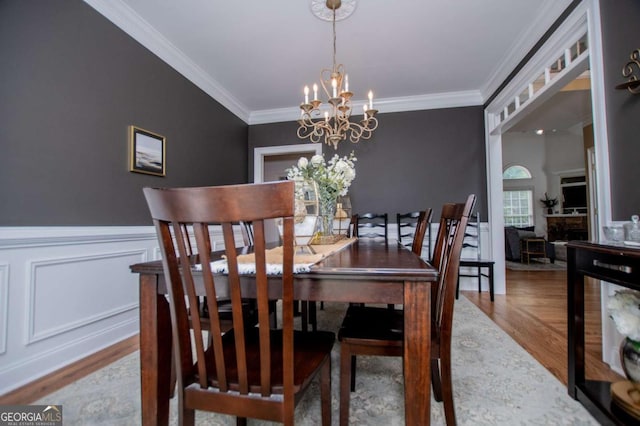 204 Pinehurst Way, Carrollton, GA 30116 - dining room with a chandelier, wood finished floors, crown molding, and wainscoting