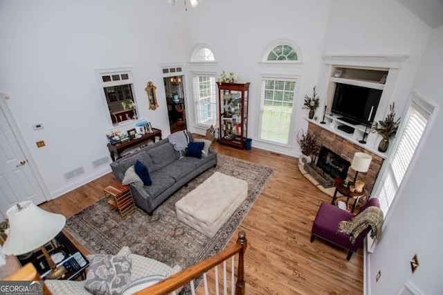 204 Pinehurst Way, Carrollton, GA 30116 - living area with a fireplace, a towering ceiling, and wood finished floors