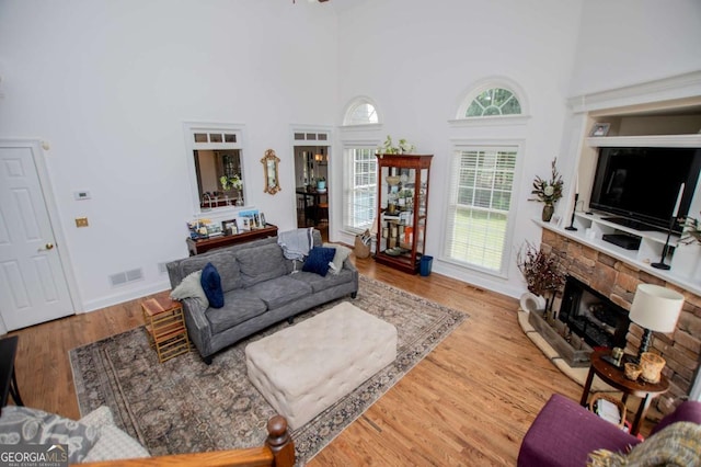 204 Pinehurst Way, Carrollton, GA 30116 - living area with a towering ceiling, a stone fireplace, and wood finished floors