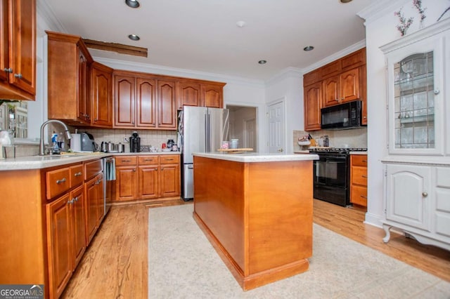 204 Pinehurst Way, Carrollton, GA 30116 - kitchen with black appliances, a kitchen island, light countertops, backsplash, and ornamental molding