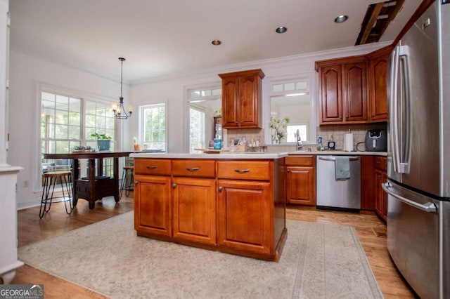 204 Pinehurst Way, Carrollton, GA 30116 - kitchen featuring stainless steel appliances, light wood-style flooring, light countertops, brown cabinets, and tasteful backsplash