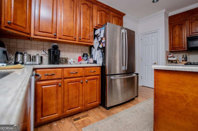 204 Pinehurst Way, Carrollton, GA 30116 - kitchen with black appliances, light countertops, light wood finished floors, decorative backsplash, and ornamental molding