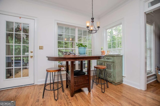 204 Pinehurst Way, Carrollton, GA 30116 - dining area with crown molding, wood finished floors, and a chandelier