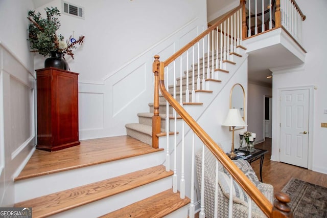 204 Pinehurst Way, Carrollton, GA 30116 - stairway with wood finished floors and a decorative wall