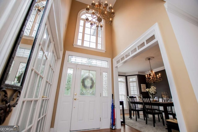 204 Pinehurst Way, Carrollton, GA 30116 - entryway with a chandelier, a towering ceiling, healthy amount of natural light, crown molding, and wood finished floors