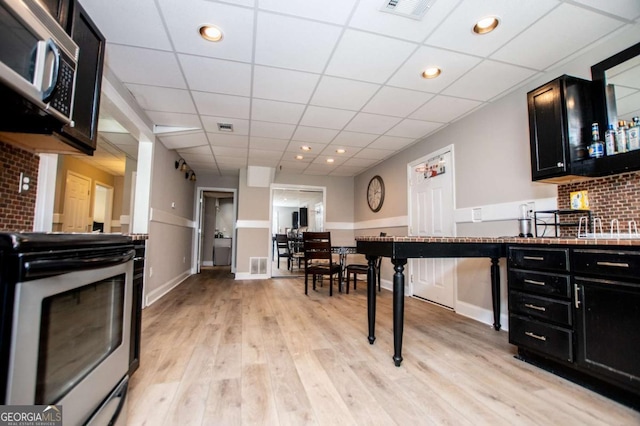 204 Pinehurst Way, Carrollton, GA 30116 - kitchen with dark cabinets, stainless steel range with electric stovetop, light wood-style floors, a drop ceiling, and recessed lighting