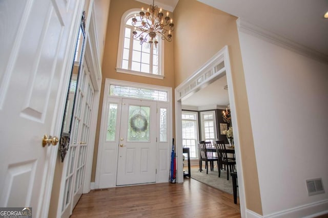 204 Pinehurst Way, Carrollton, GA 30116 - entrance foyer featuring a chandelier, wood finished floors, and crown molding