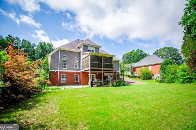 204 Pinehurst Way, Carrollton, GA 30116 - rear view of house featuring a sunroom, a yard, brick siding, a patio area, and stairs