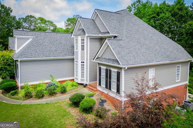 204 Pinehurst Way, Carrollton, GA 30116 - back of house featuring roof with shingles, a lawn, and brick siding
