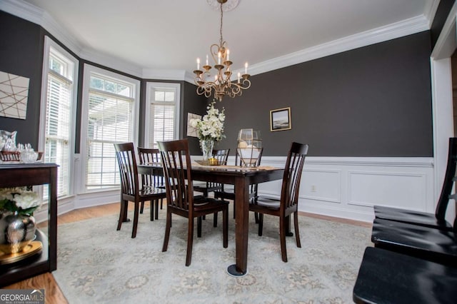 204 Pinehurst Way, Carrollton, GA 30116 - dining area featuring healthy amount of natural light, crown molding, a chandelier, wood finished floors, and a wainscoted wall