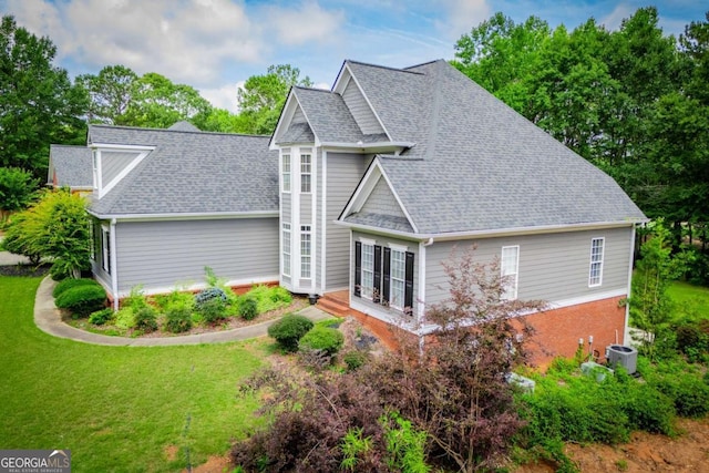204 Pinehurst Way, Carrollton, GA 30116 - view of home's exterior featuring a yard and roof with shingles