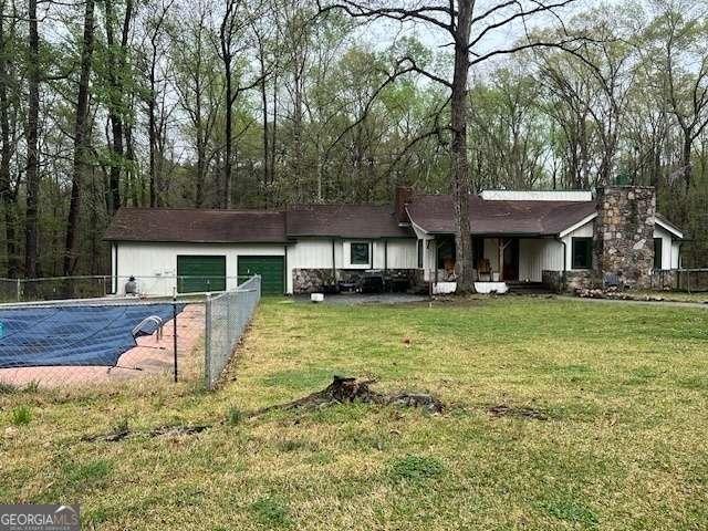 2497 Old Jackson Rd, Locust Grove, GA 30248 - view of front facade featuring a chimney and an attached garage