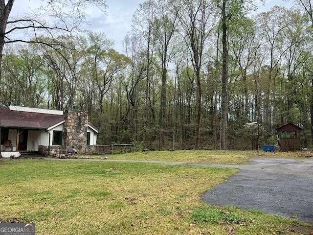 2497 Old Jackson Rd, Locust Grove, GA 30248 - view of grassy yard featuring driveway