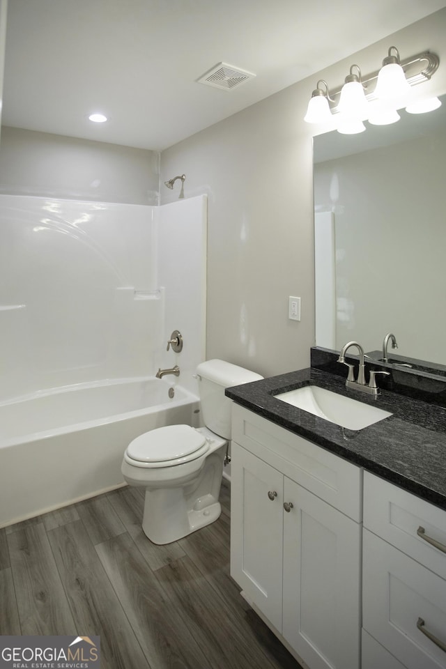 266 Patillo Rd, Jackson, GA 30233 - full bath featuring vanity, wood finished floors, shower / washtub combination, and recessed lighting
