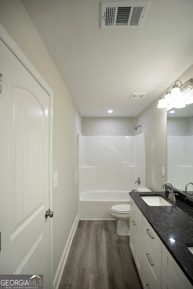 266 Patillo Rd, Jackson, GA 30233 - bathroom with wood finished floors, double vanity, tub / shower combination, and recessed lighting