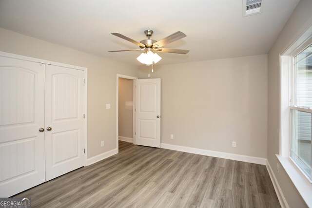 266 Patillo Rd, Jackson, GA 30233 - unfurnished bedroom with light wood-type flooring, a closet, and ceiling fan