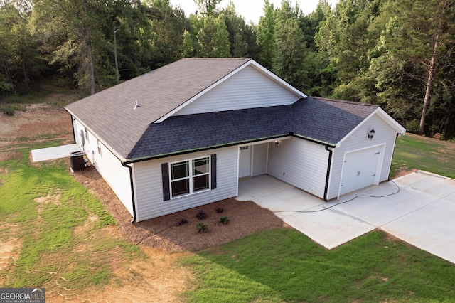 266 Patillo Rd, Jackson, GA 30233 - view of front of home featuring a shingled roof, an attached garage, a front yard, driveway, and a wooded view