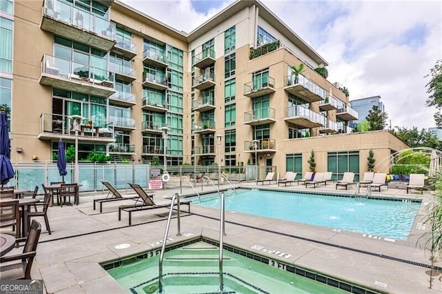 905 Juniper St NE Unit 701, Atlanta, GA 30309 - community pool featuring a hot tub and a patio area