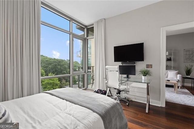 905 Juniper St NE Unit 701, Atlanta, GA 30309 - bedroom featuring wood finished floors, floor to ceiling windows, and a desk