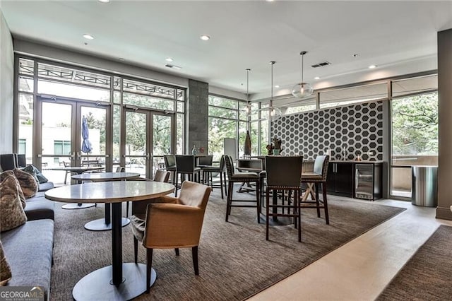 905 Juniper St NE Unit 701, Atlanta, GA 30309 - dining space with wine cooler, recessed lighting, healthy amount of natural light, concrete flooring, and french doors