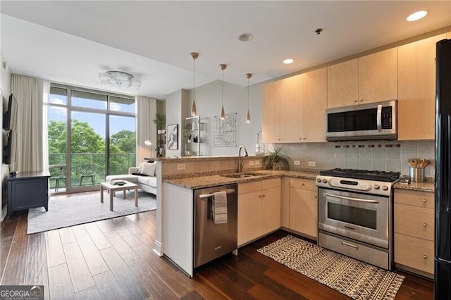 905 Juniper St NE Unit 701, Atlanta, GA 30309 - kitchen with stainless steel appliances, a peninsula, dark wood-type flooring, tasteful backsplash, and expansive windows