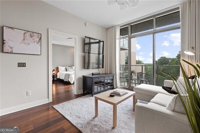 905 Juniper St NE Unit 701, Atlanta, GA 30309 - living area with wood finished floors, a chandelier, and a wall of windows