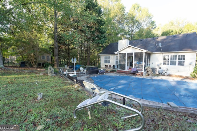 1858 Mcconnell Rd, Grayson, GA 30017 - rear view of property with a sunroom, a chimney, and a covered pool
