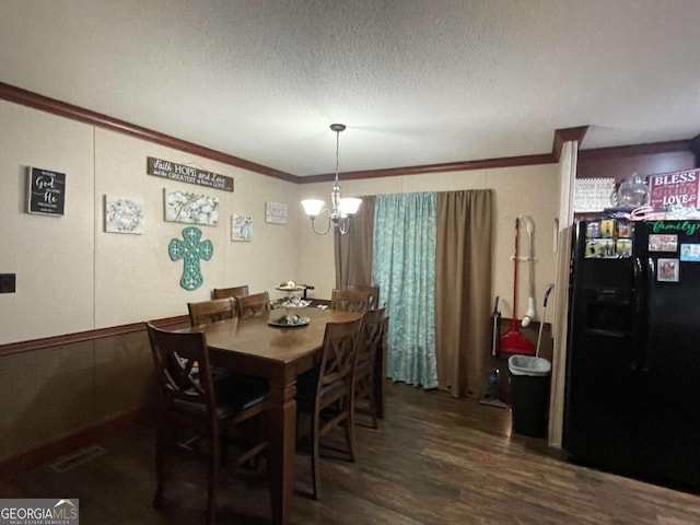 601 Auburn Rd, Glennville, GA 30427 - dining area with crown molding, dark wood finished floors, a chandelier, and a textured ceiling