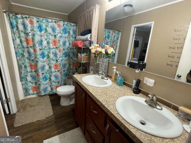 601 Auburn Rd, Glennville, GA 30427 - bathroom featuring wood finished floors, double vanity, a textured ceiling, and curtained shower