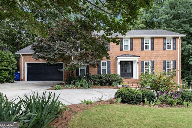 1379 Cambridge Ct NE, Brookhaven, GA 30319 - colonial house with concrete driveway, french doors, brick siding, an attached garage, and a front lawn