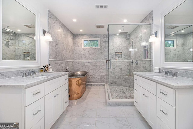1379 Cambridge Ct NE, Brookhaven, GA 30319 - full bath featuring a marble finish shower, marble look tile flooring, two vanities, tile walls, and recessed lighting