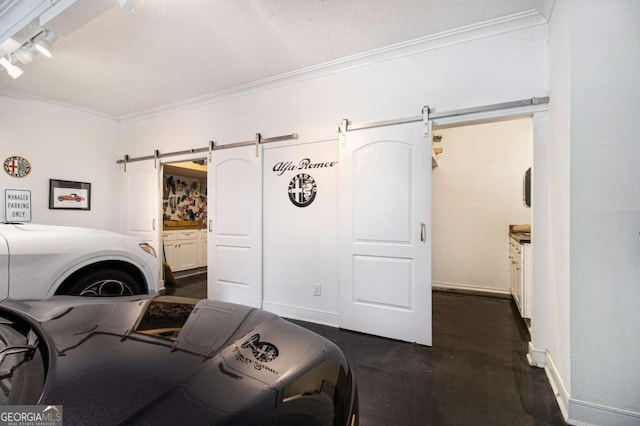 1379 Cambridge Ct NE, Brookhaven, GA 30319 - laundry room with a barn door, ornamental molding, track lighting, and washer and clothes dryer
