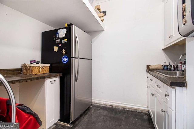1379 Cambridge Ct NE, Brookhaven, GA 30319 - kitchen with freestanding refrigerator, dark countertops, and white cabinets