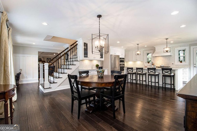 1379 Cambridge Ct NE, Brookhaven, GA 30319 - dining area featuring stairs, recessed lighting, dark wood-type flooring, crown molding, and a chandelier