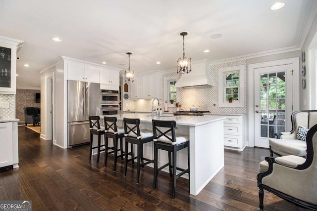 1379 Cambridge Ct NE, Brookhaven, GA 30319 - kitchen with stainless steel appliances, custom exhaust hood, light countertops, decorative backsplash, and healthy amount of natural light