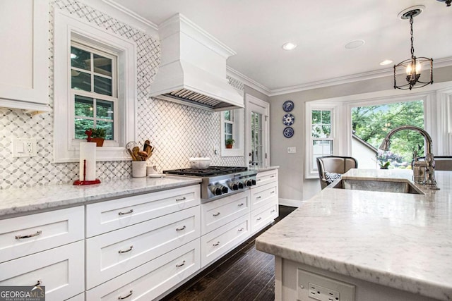 1379 Cambridge Ct NE, Brookhaven, GA 30319 - kitchen featuring stainless steel gas stovetop, premium range hood, tasteful backsplash, crown molding, and white cabinets