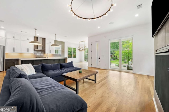 32 Walthall St NE Unit A, Atlanta, GA 30307 - living room with plenty of natural light, light wood-style flooring, a chandelier, and recessed lighting