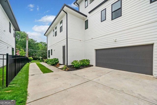 32 Walthall St NE Unit A, Atlanta, GA 30307 - view of side of home featuring concrete driveway and a garage