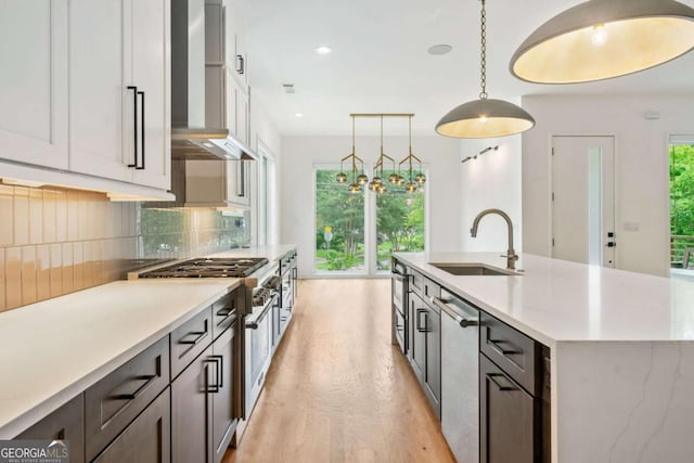 32 Walthall St NE Unit A, Atlanta, GA 30307 - kitchen with wall chimney exhaust hood, stainless steel appliances, light countertops, decorative backsplash, and recessed lighting