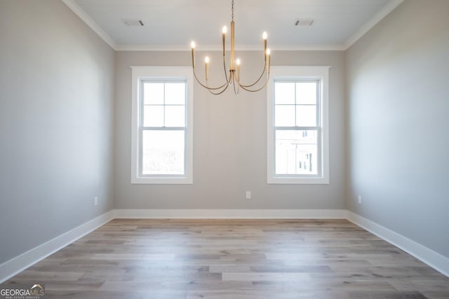 145 Holmes Ave, Athens, GA 30606 - unfurnished room with ornamental molding, a chandelier, healthy amount of natural light, and light wood-style floors