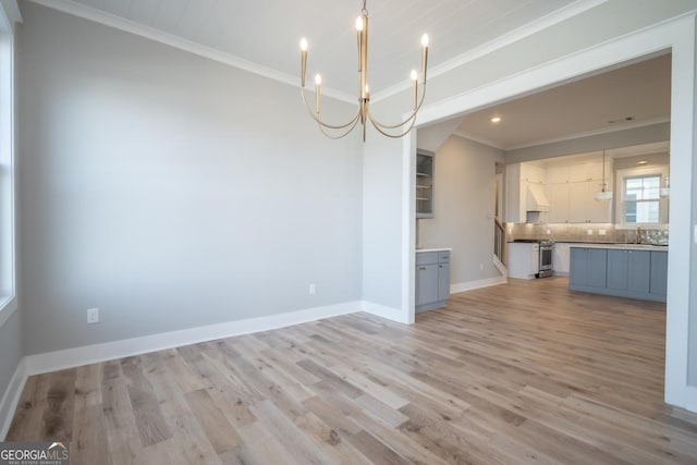 145 Holmes Ave, Athens, GA 30606 - kitchen featuring a chandelier, ornamental molding, backsplash, light wood-style floors, and pendant lighting