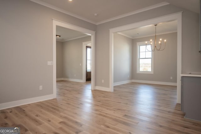 145 Holmes Ave, Athens, GA 30606 - empty room with light wood-style floors, a chandelier, and crown molding