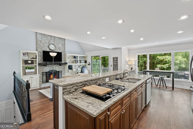 3648 Sope Creek Farm SE, Marietta, GA 30067 - kitchen with gas stovetop, a center island with sink, dark wood finished floors, light stone countertops, and recessed lighting