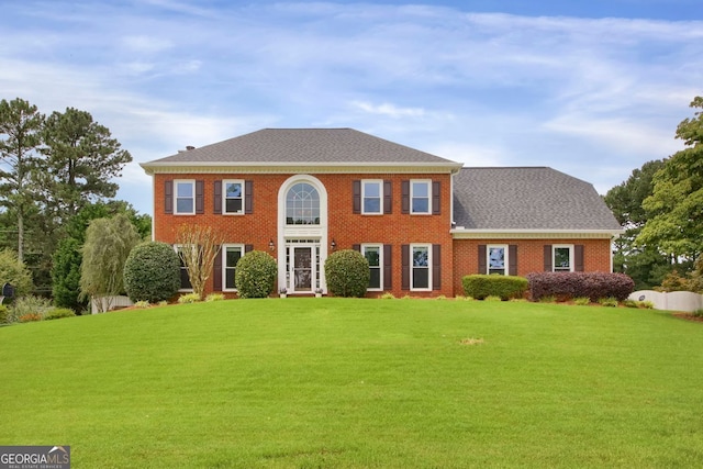 1197 Kenilworth Trce, Snellville, GA 30078 - colonial house featuring a front lawn, brick siding, and a shingled roof