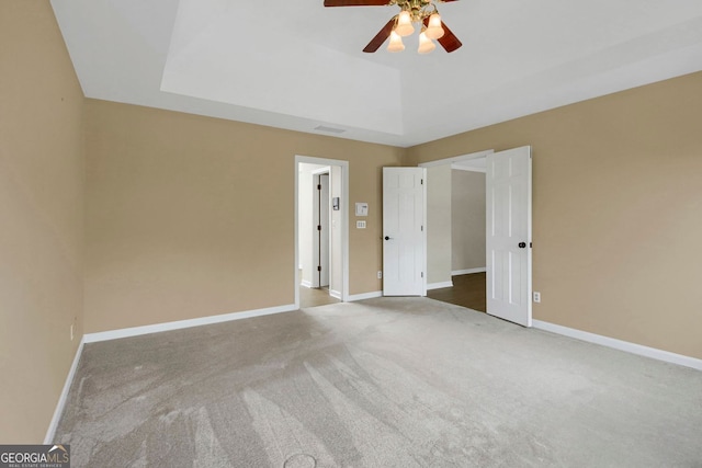 1197 Kenilworth Trce, Snellville, GA 30078 - unfurnished bedroom featuring carpet flooring, a tray ceiling, and ceiling fan