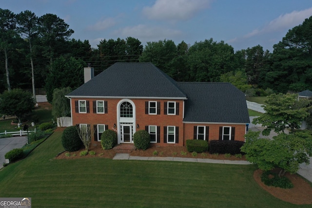 1197 Kenilworth Trce, Snellville, GA 30078 - colonial home featuring a chimney, a front yard, and brick siding