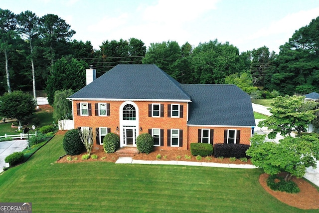 1197 Kenilworth Trce, Snellville, GA 30078 - colonial-style house with a chimney, a front lawn, brick siding, and a shingled roof