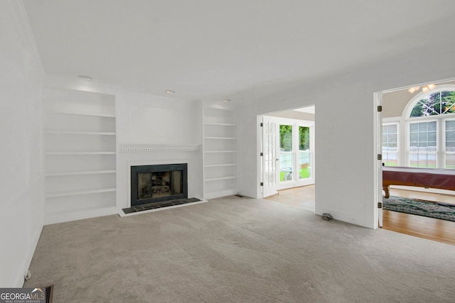 1197 Kenilworth Trce, Snellville, GA 30078 - unfurnished living room featuring carpet floors, a fireplace with flush hearth, and built in features